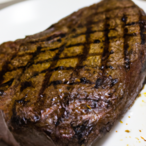 A perfectly grilled steak with grill marks on a plate